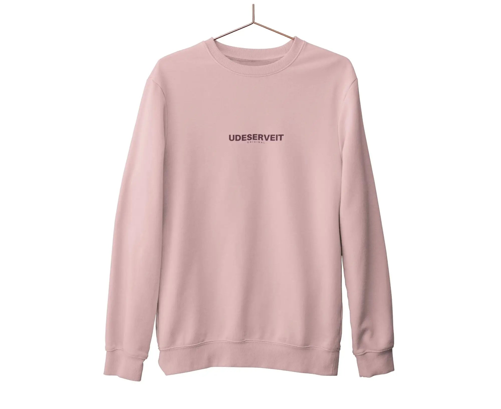 Pink sweatshirt with 'UDESERVEIT' text on a white background