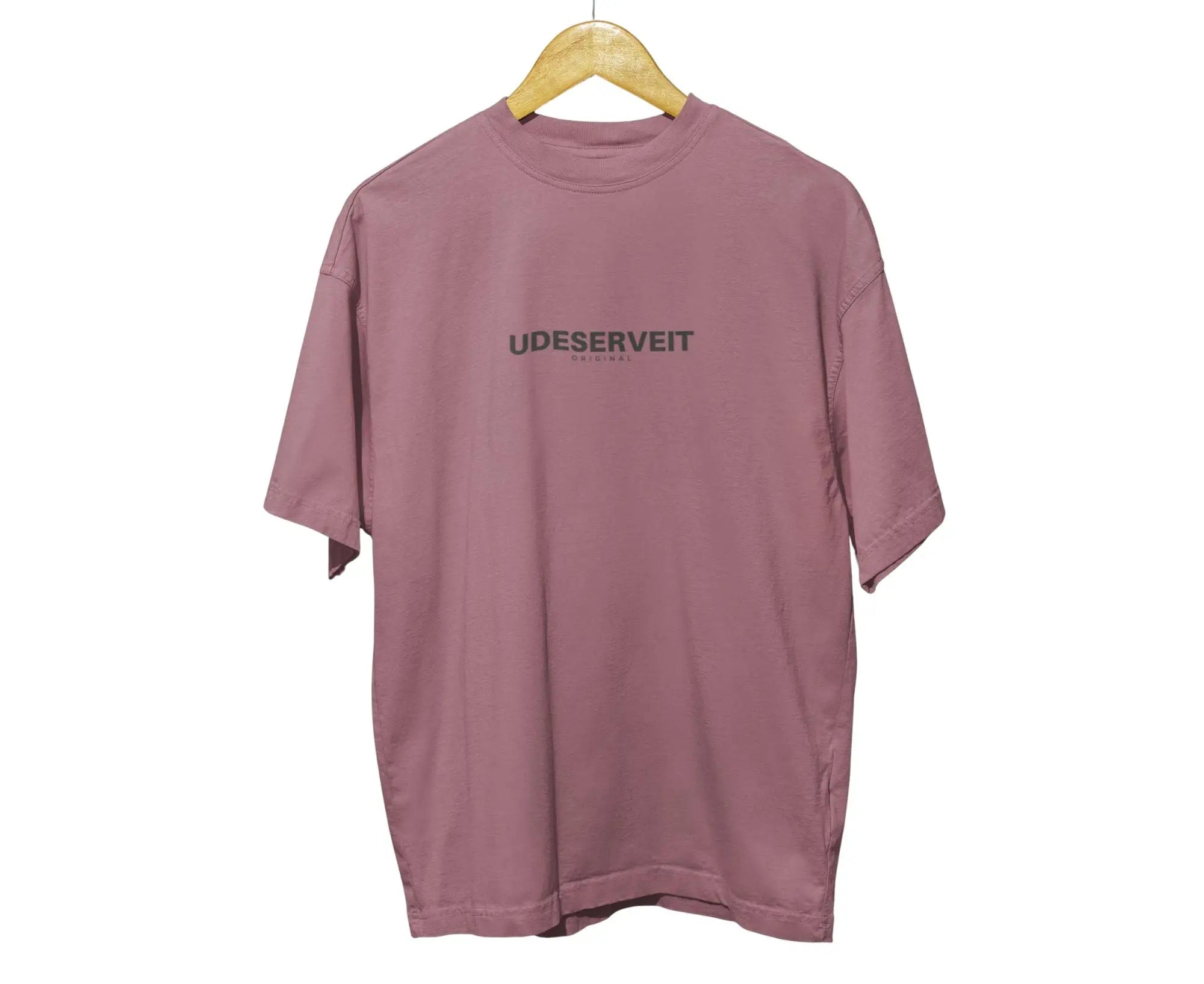 Mauve t-shirt with 'UDESERVEIT' text on a hanger against a white background