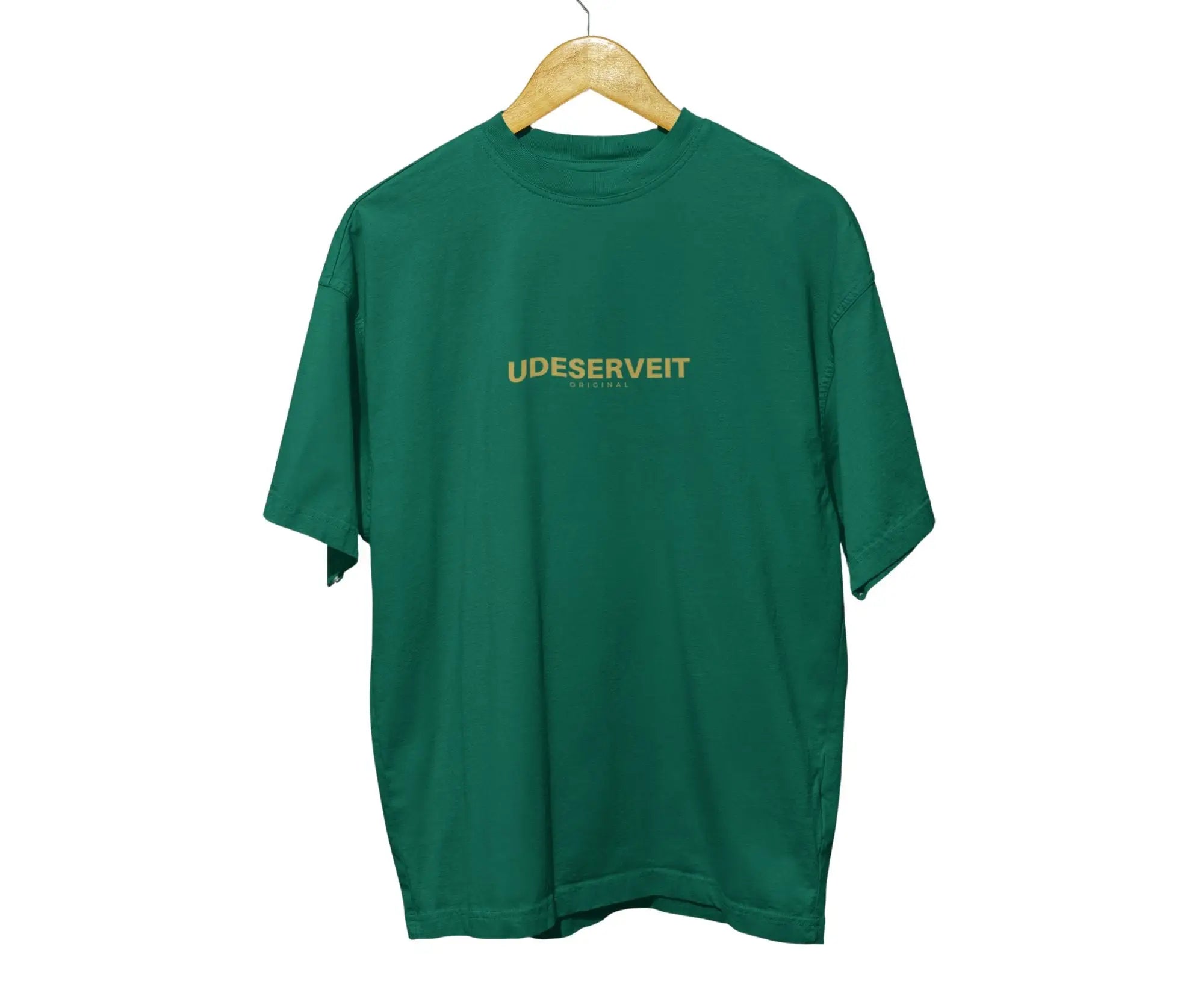 Green t-shirt with 'UDESERVEIT' text on a wooden hanger against a white background